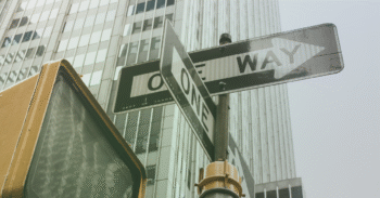 one way sign pointing in multiple direction, representing cross-border payment differentiators such as reach, visibility and reliability