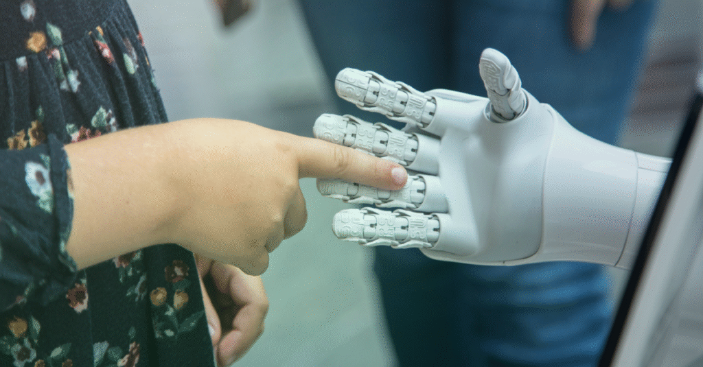 Person's hand reaching out to touch a white robotic hand, representing AI in payments.